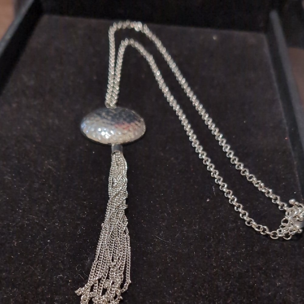 Elegant silver-tone tassel pendant necklace.